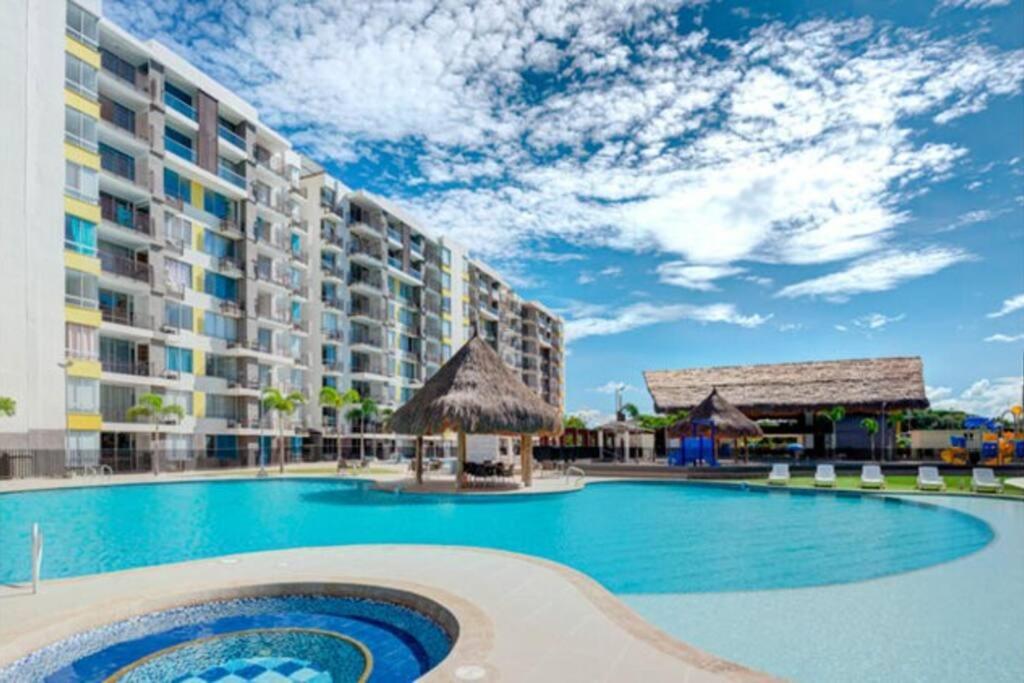 a large swimming pool in front of a hotel at Marquis Enclave, Condo With Pool Access and More in Ricaurte