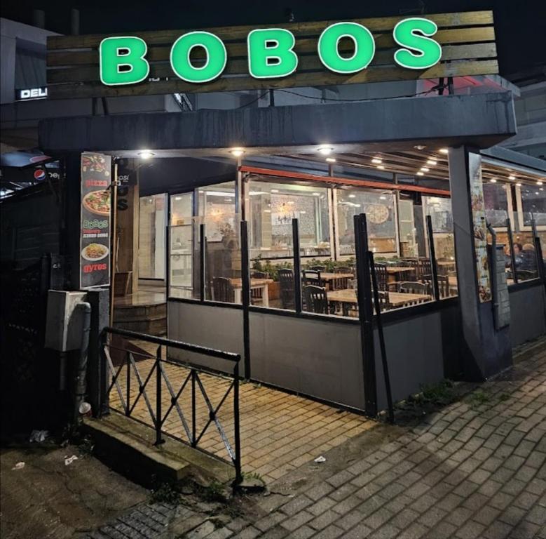 a restaurant with a sign that reads bosos at Apartment by the Sea, Peraia Thessaloniki in Perea