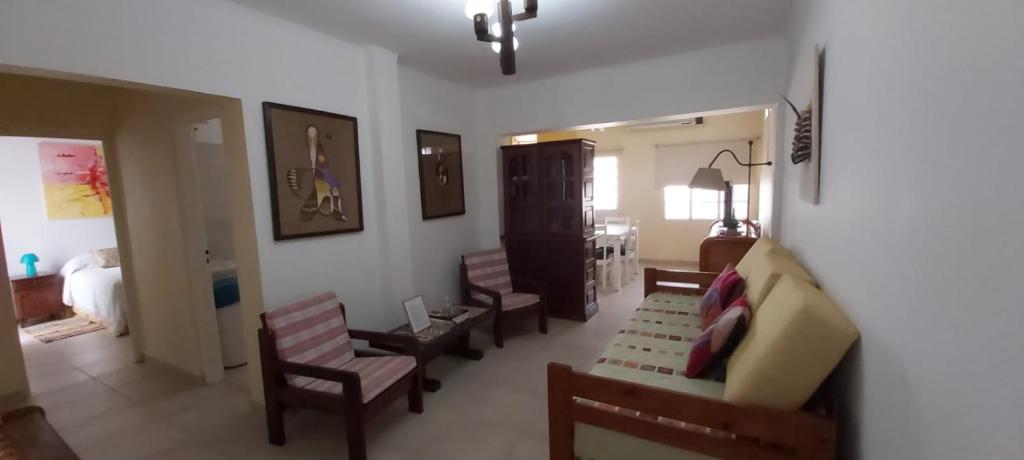 a living room with a couch and chairs and a bedroom at La Casa de Mirna in Formosa