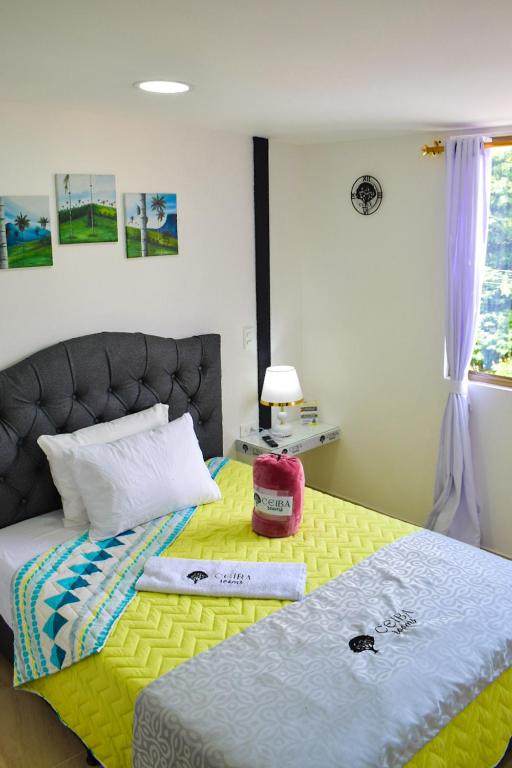 Postel nebo postele na pokoji v ubytování Ayenda Ceiba Rooms