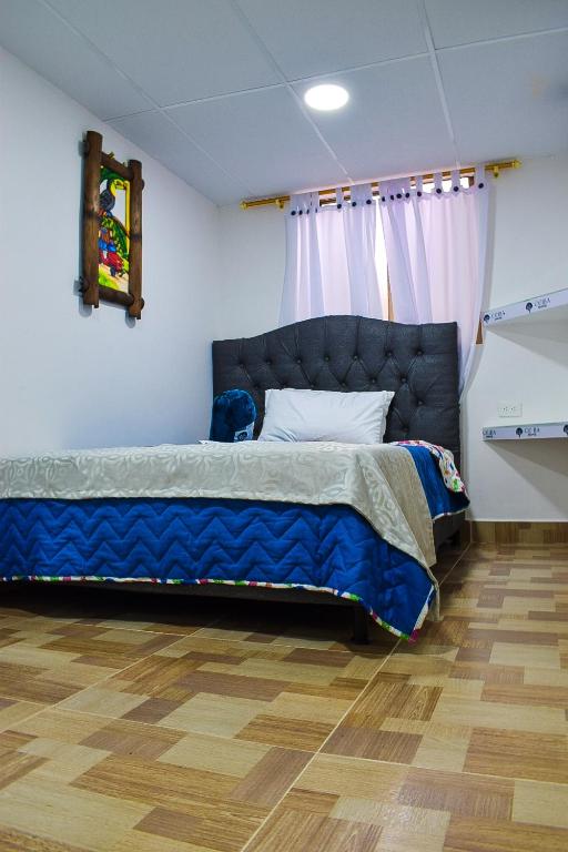 Postel nebo postele na pokoji v ubytování Ayenda Ceiba Rooms