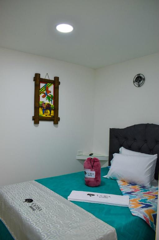 Postel nebo postele na pokoji v ubytování Ayenda Ceiba Rooms