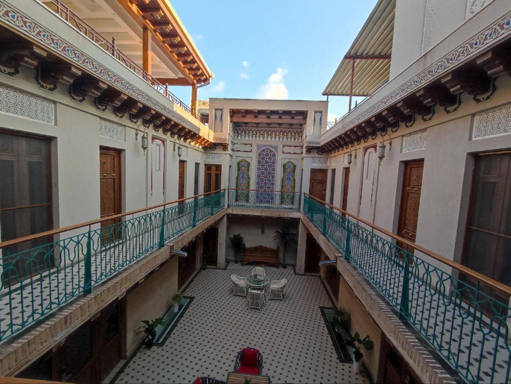 an overhead view of a balcony of a building with a table at Asal boutique hotel in Bukhara