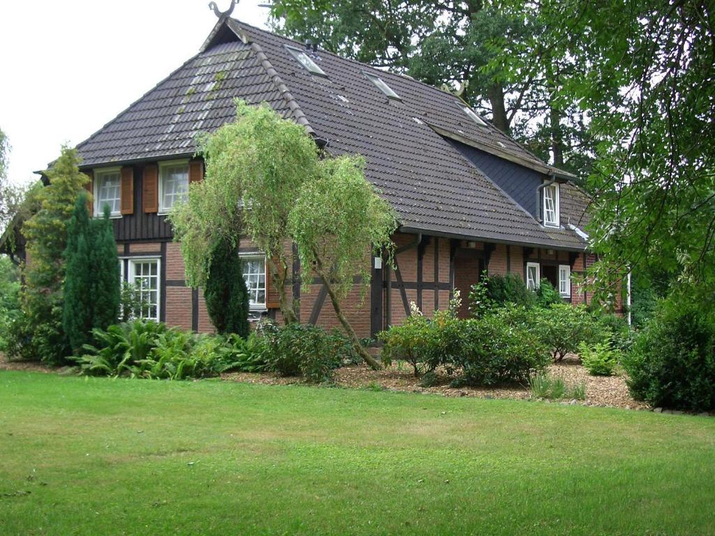 ein braunes Haus mit einem Gameradach in der Unterkunft Ferienwohnungen Manfred Peters Baven in Hermannsburg