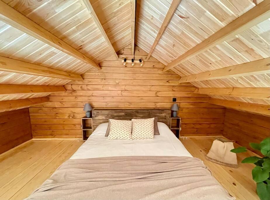 a large bed in a room with wooden walls at Mountain Eco Shelter 6 in Funchal