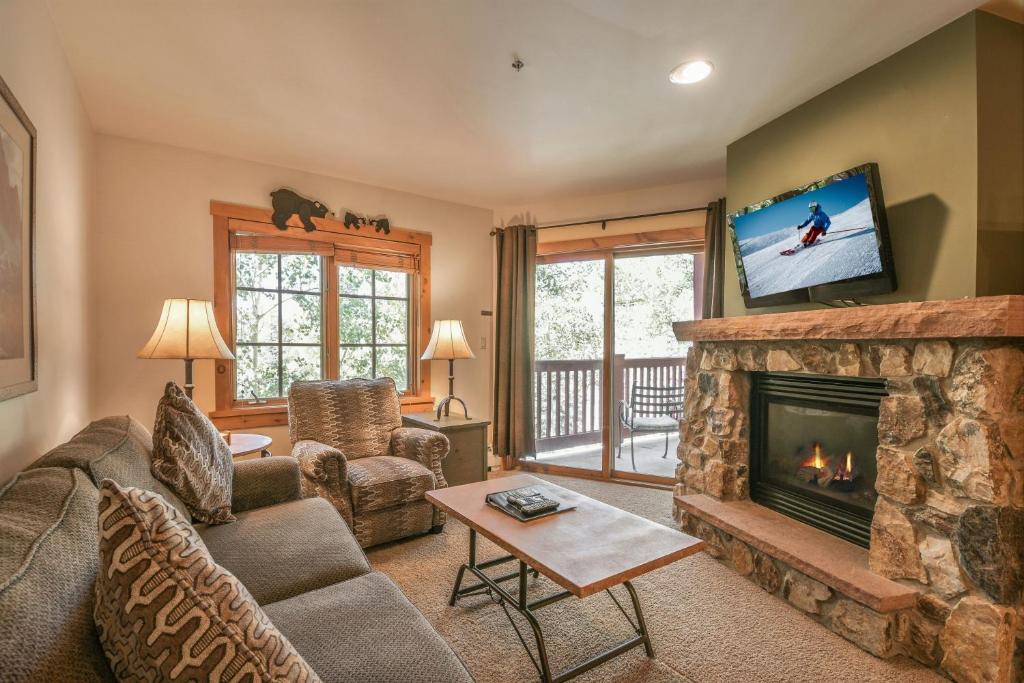a living room with a couch and a fireplace at Expedition Station 8622 in Keystone