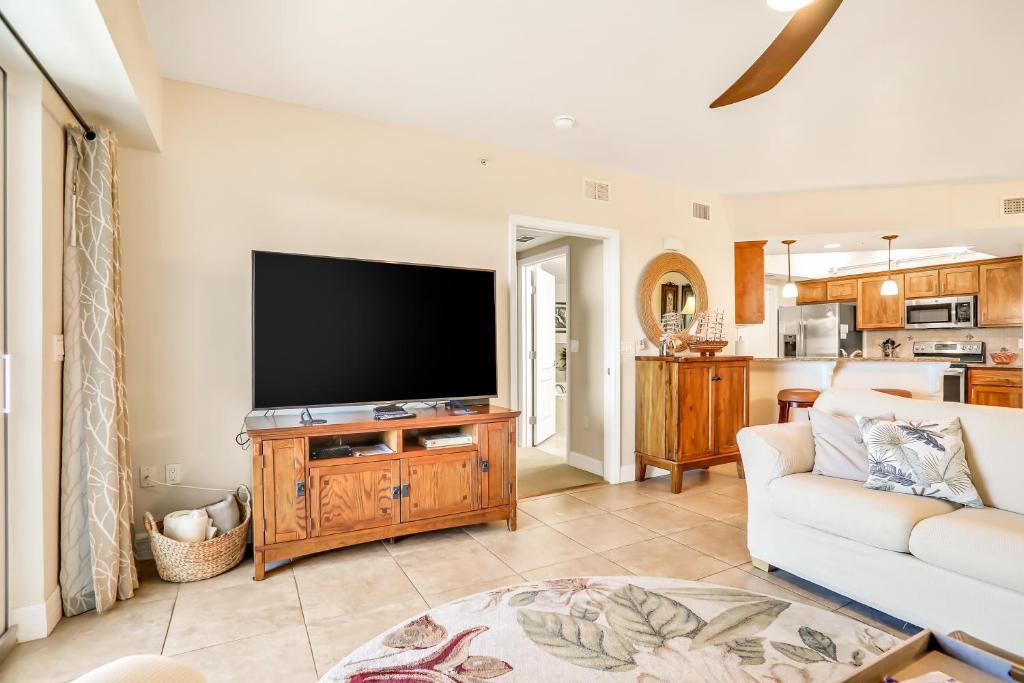 a living room with a flat screen tv and a couch at Oceanwalk 17-406 in New Smyrna Beach