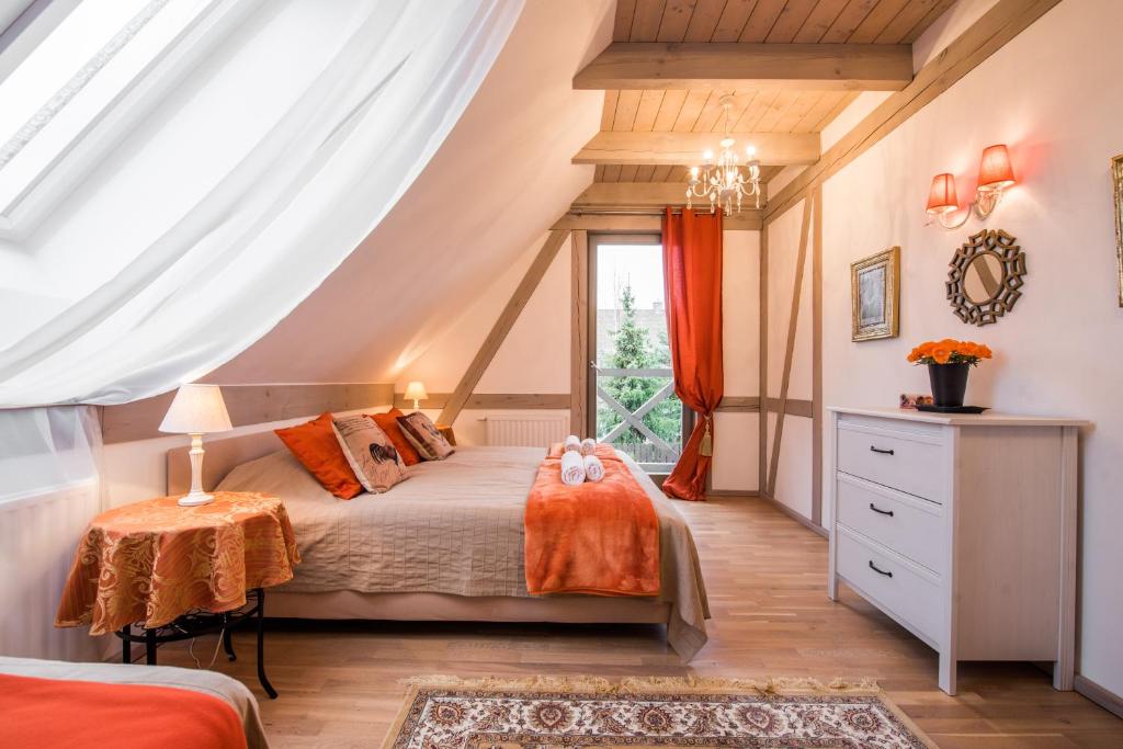 a bedroom with a bed and a window at Villa Mela in Mikołajki
