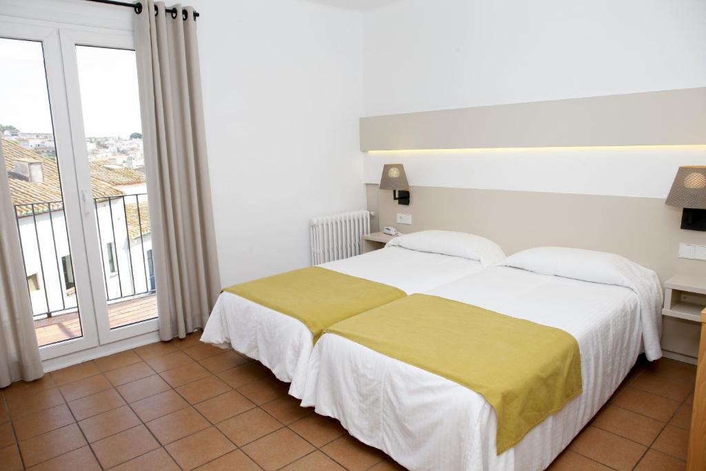 Postel nebo postele na pokoji v ubytování Hotel Ubaldo