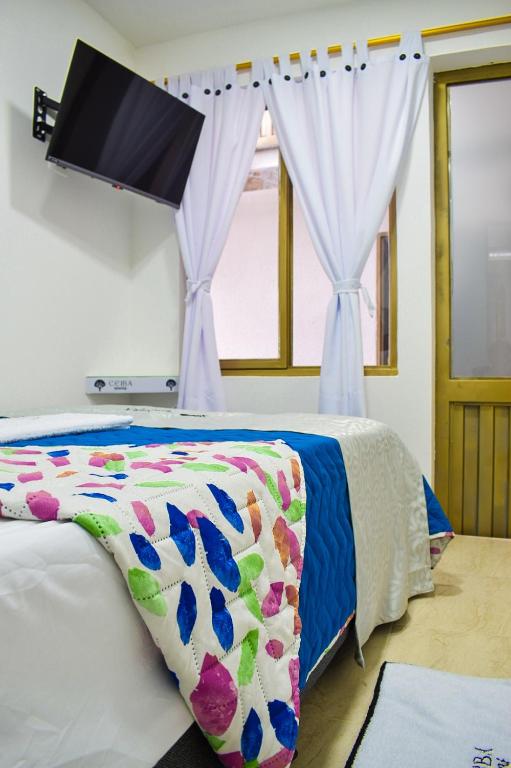 Postel nebo postele na pokoji v ubytování Ayenda Ceiba Rooms