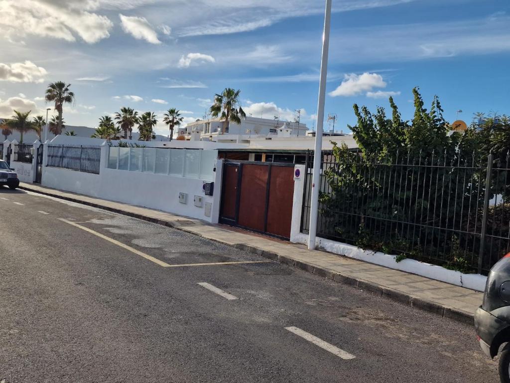 a white building on the side of a road at Casa Playa Chica Lanzarote in Puerto del Carmen