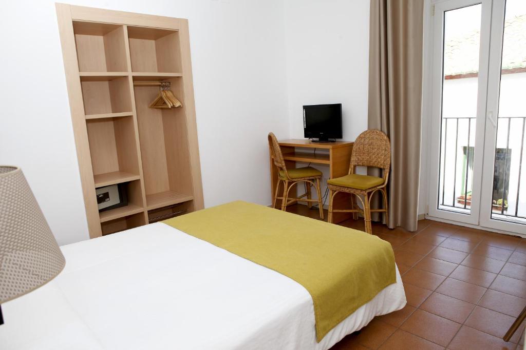 Postel nebo postele na pokoji v ubytování Hotel Ubaldo