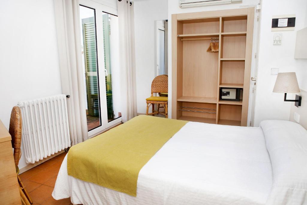 Postel nebo postele na pokoji v ubytování Hotel Ubaldo