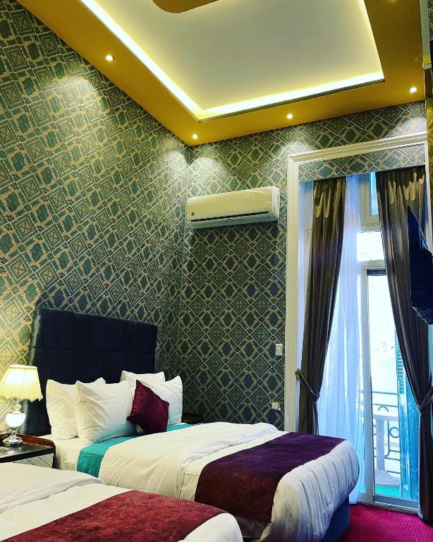 Postel nebo postele na pokoji v ubytování Cairo Inn