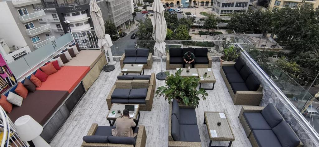 an overhead view of a rooftop patio with tables and chairs at Marco Polo Party Hostel in St. Julianʼs