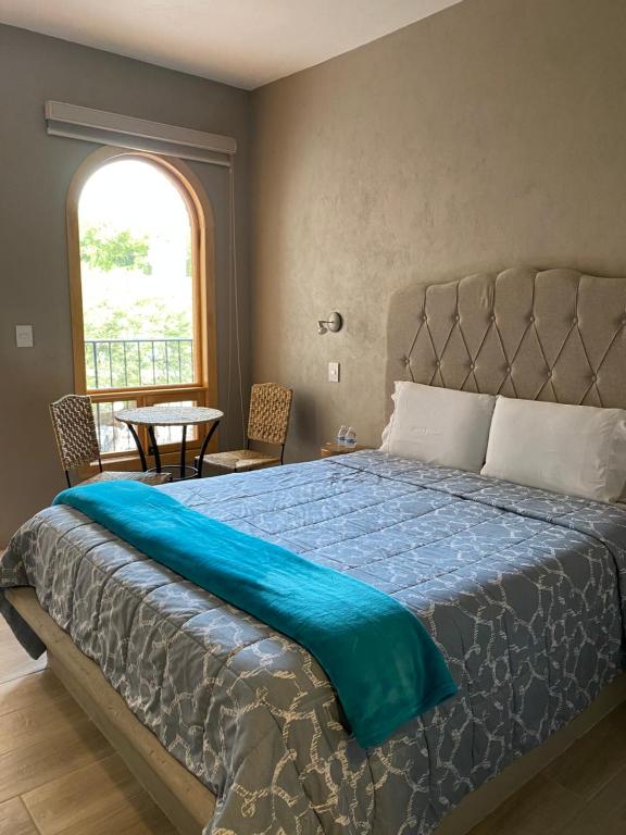 Postel nebo postele na pokoji v ubytování Hotel Casa Caro