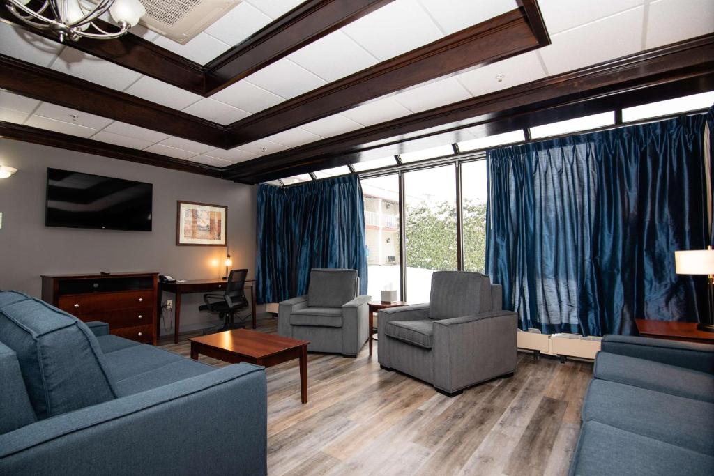 a living room with couches and chairs and a table at Best Western Plus Plattsburgh in Plattsburgh