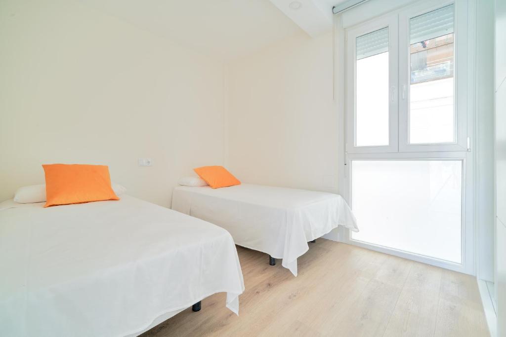 Łóżko lub łóżka w pokoju w obiekcie Impresionante apartamento en Playa de la Malagueta
