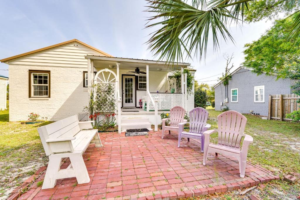 a group of chairs sitting on a brick patio at Lovely Panama City Cottage Walk to Bayside Beach! in Panama City