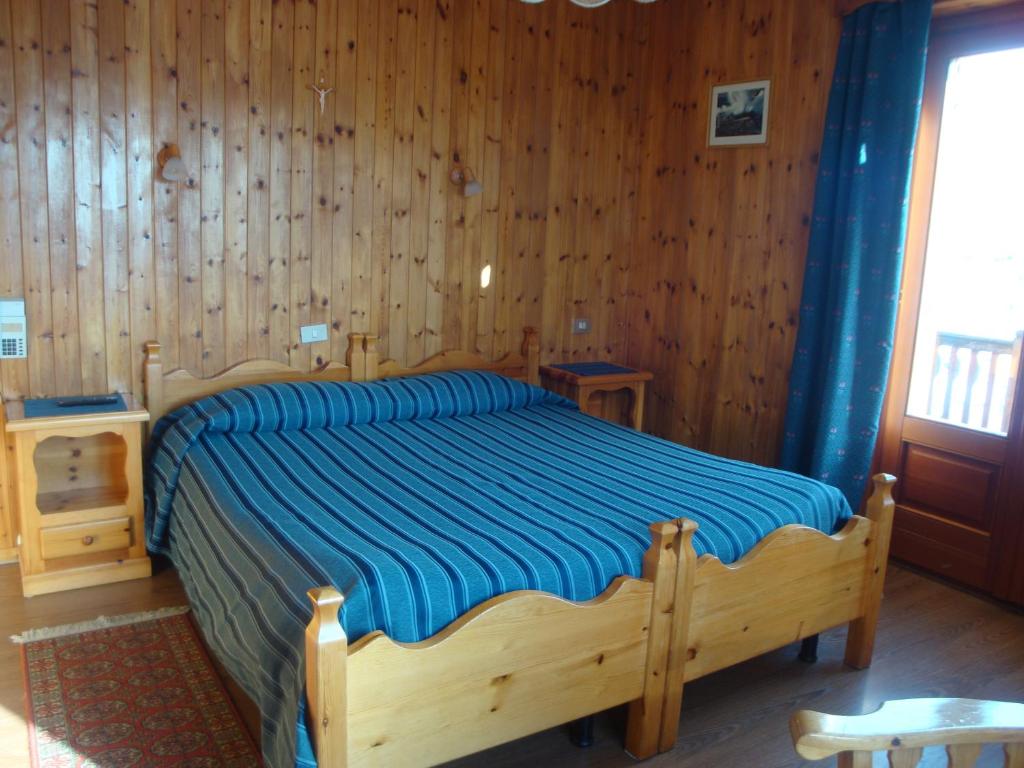 Postel nebo postele na pokoji v ubytování Hotel Alpe Fleurie