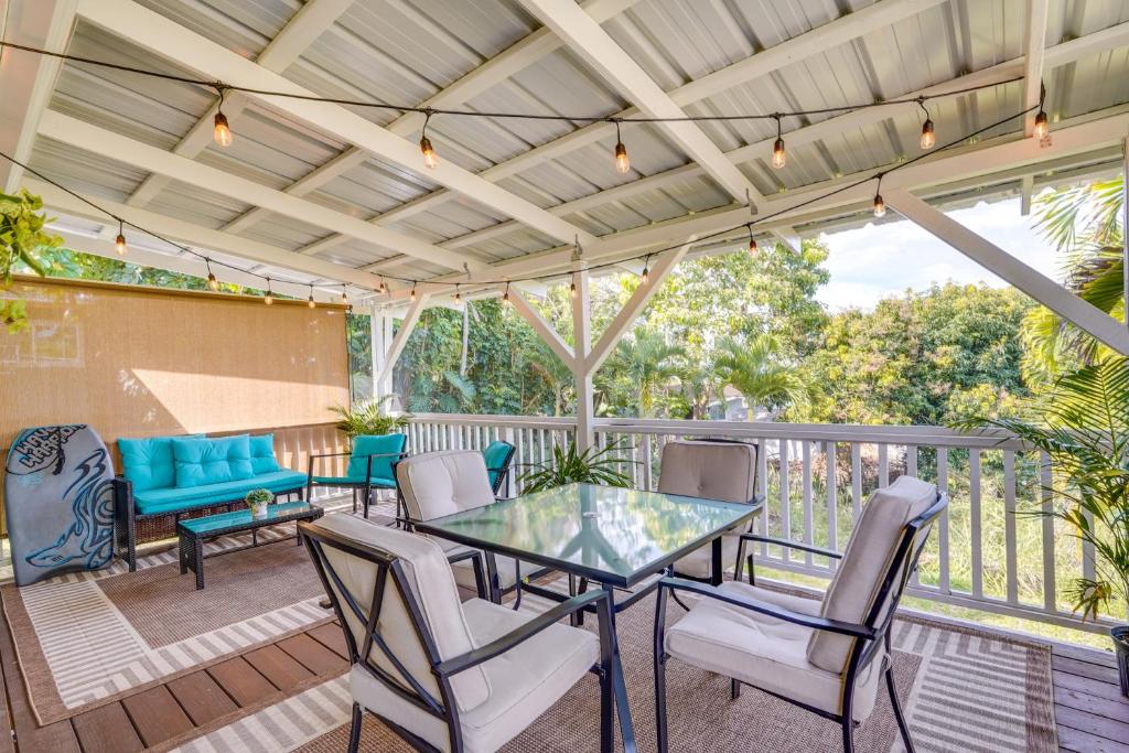 a patio with a glass table and chairs at Lovely Kailua-Kona Home about 2 Mi to Town and Beach! in Kailua-Kona