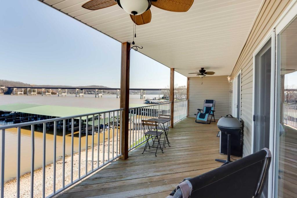 a screened porch with a tennis court on it at Lakefront Ozark Condo with Spacious Balcony! in Camdenton