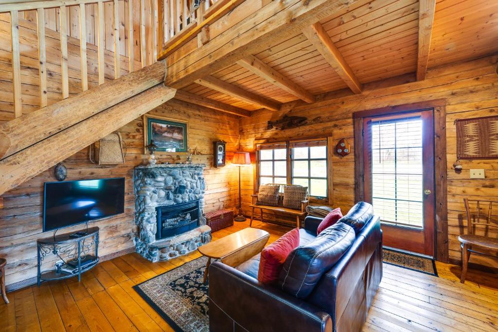 a living room with a couch and a fireplace at Blue Sky Cabin in Sequim with Private Hot Tub! in Sequim