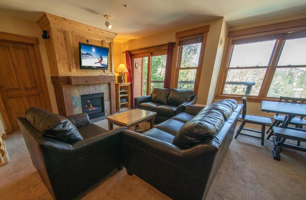 a living room with a couch and a fireplace at Springs 8870 in Keystone