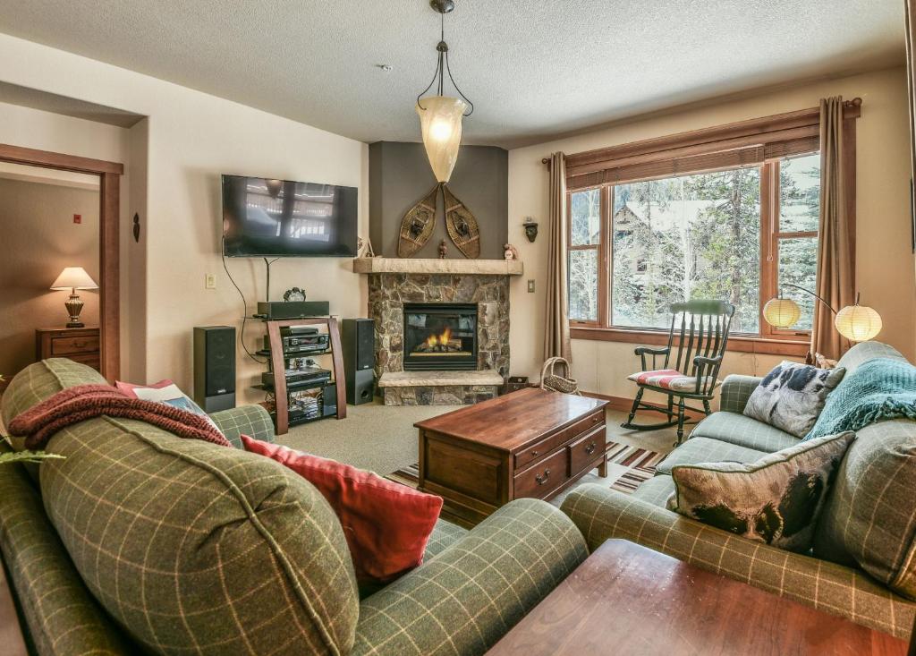 a living room with two couches and a fireplace at Red Hawk Townhomes 2333 in Keystone