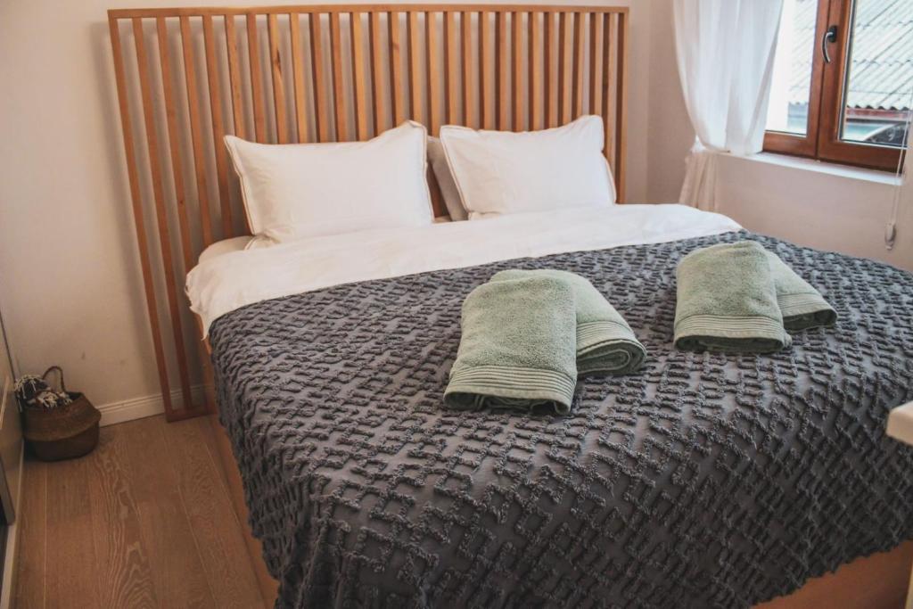 a bedroom with a bed with two towels on it at Villa Christina 2 in Ohrid