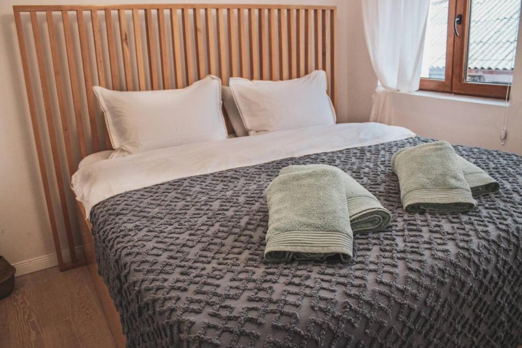 a bedroom with a bed with two towels on it at Villa Christina 2 in Ohrid