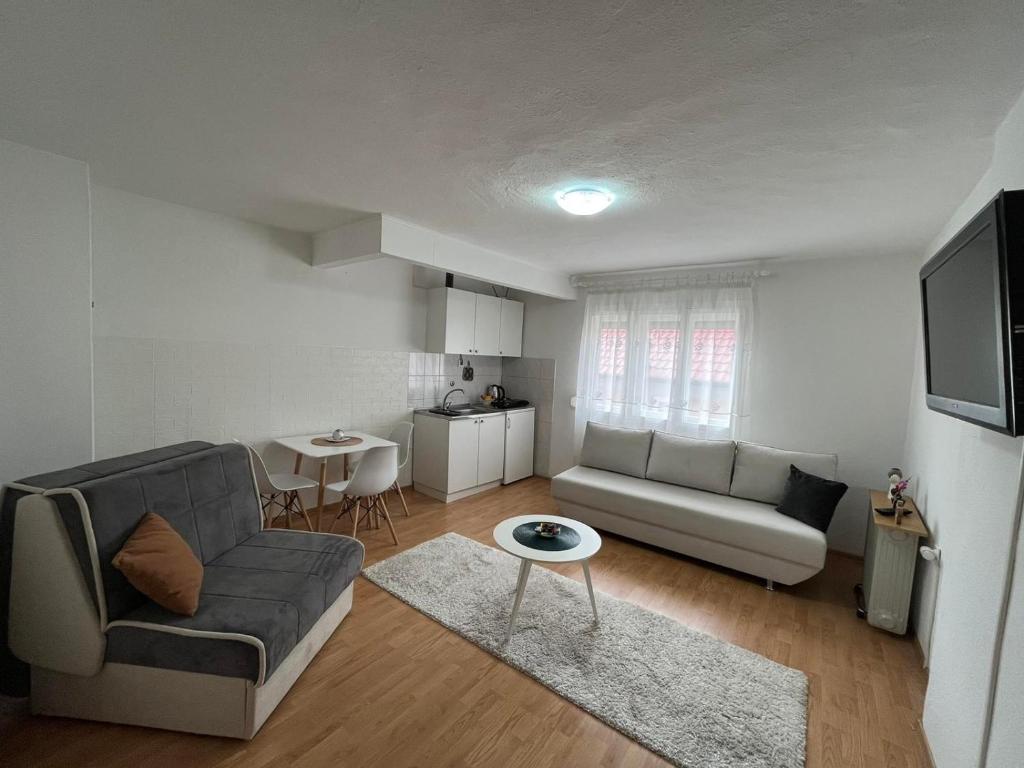 a living room with a couch and a table at Sunlight Apartments in Mostar