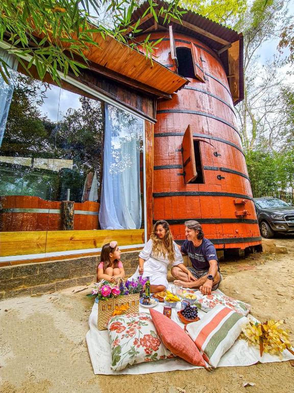 a group of people sitting in front of a tree house at Pipa Malbec in Petrópolis