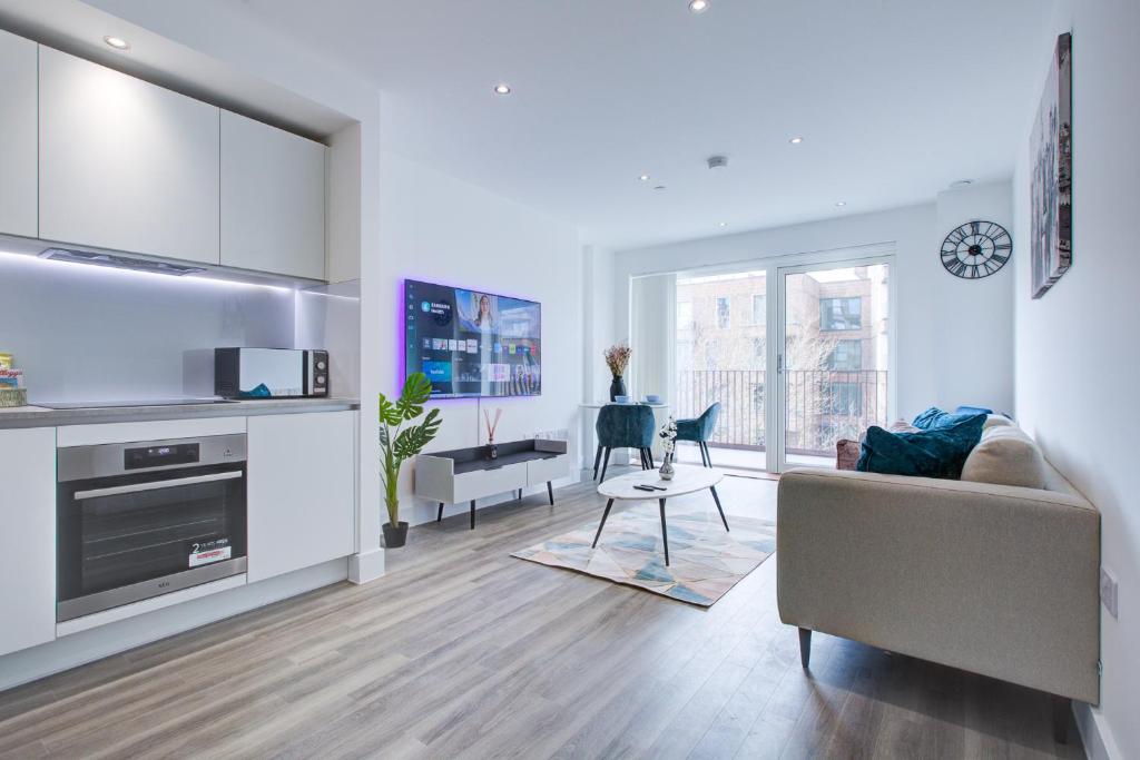 a living room with a couch and a table at Luxe Apartment by Excel in London