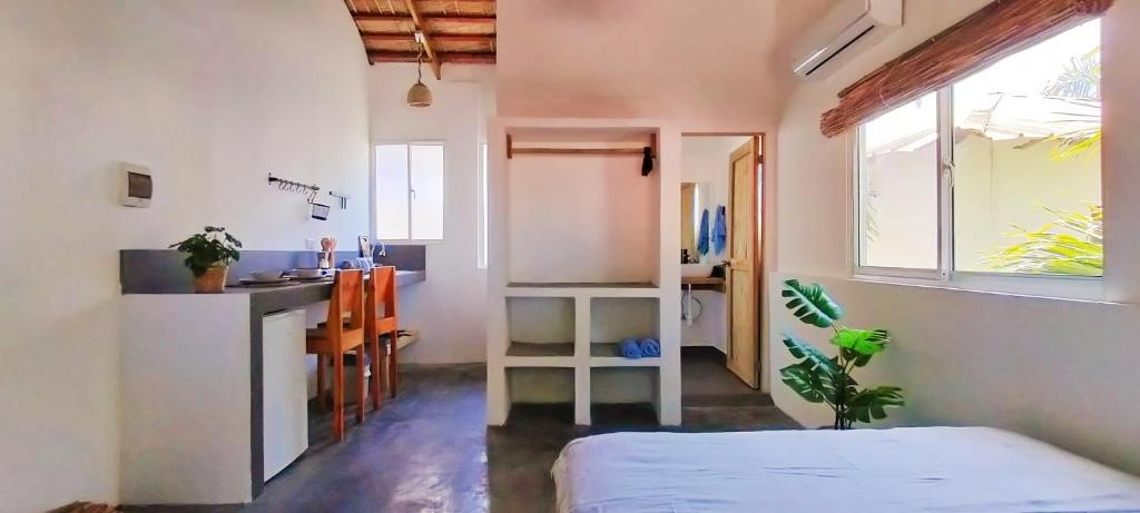 a room with a bed and a sink and a kitchen at Kite House Cabarete across Kite Beach in Cabarete