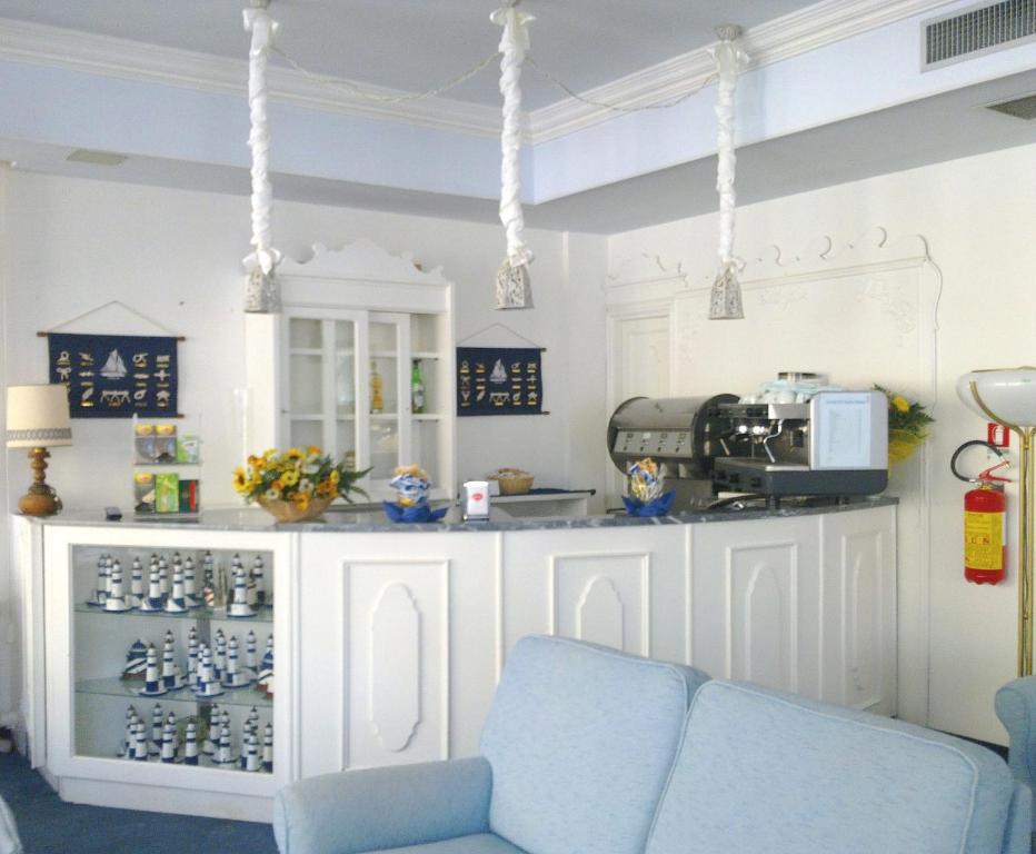 a kitchen with a blue couch and a counter at Hotel Maremonti in Gabicce Mare