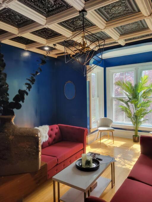 un soggiorno con divano rosso e tavolo di The Maple Shade Suite a Sussex
