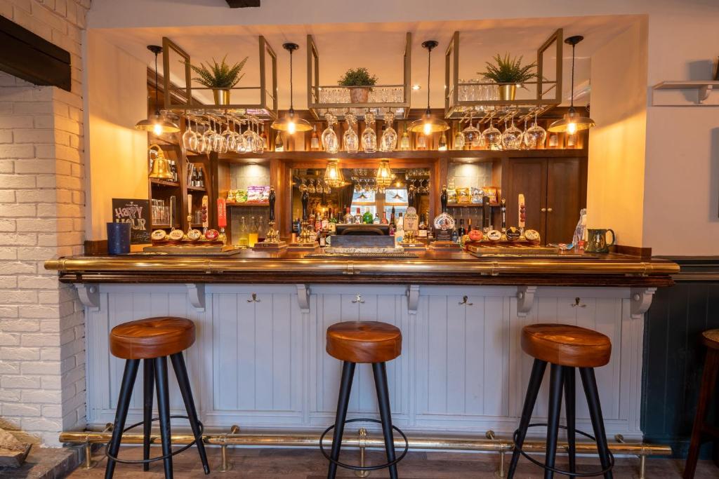 a bar with two stools in front of it at Woodroffe Arms, Hope Twin Room 5 in Hope