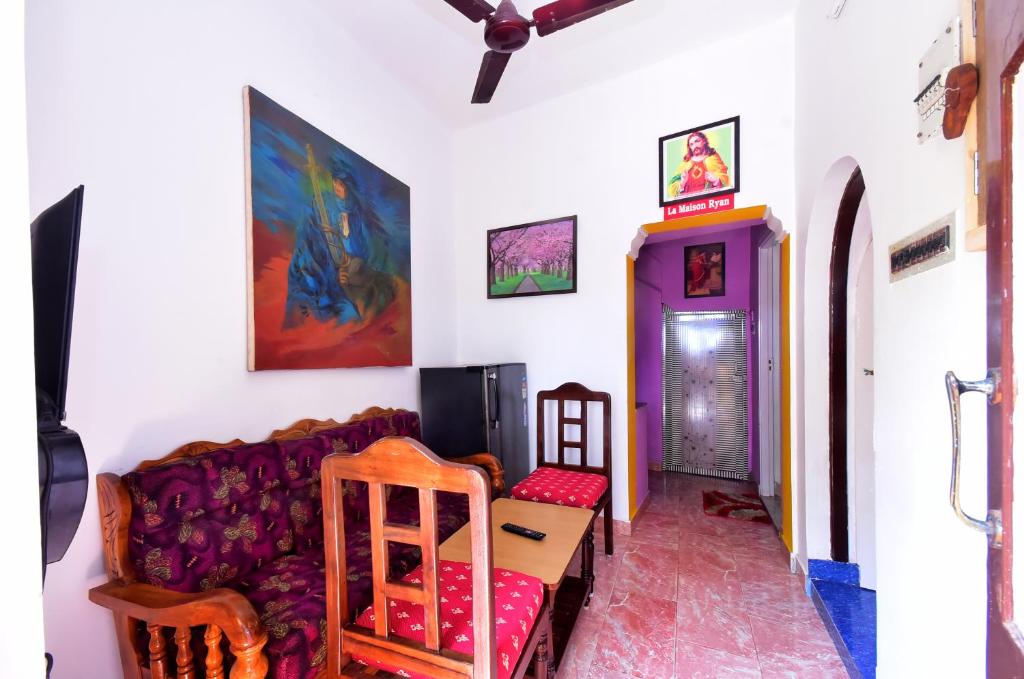 a living room with a couch and a table and chairs at Villa Betty Beach Front in Puducherry