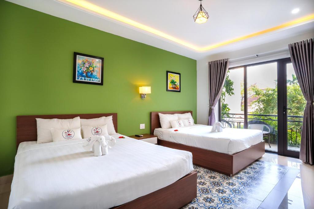 Postel nebo postele na pokoji v ubytování HAI DAO HOI AN VILLA