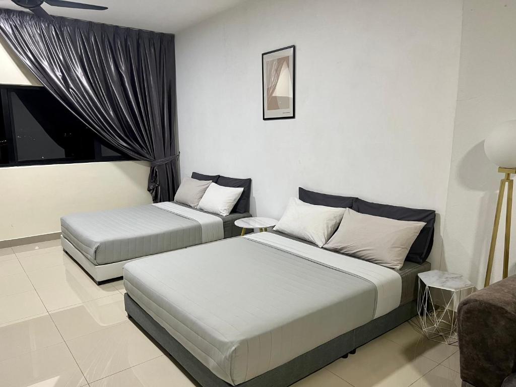 a bedroom with two beds and a window at Cozy Studio Sk 1 Residence for 4 pax UPM Mines Serdang in Seri Kembangan