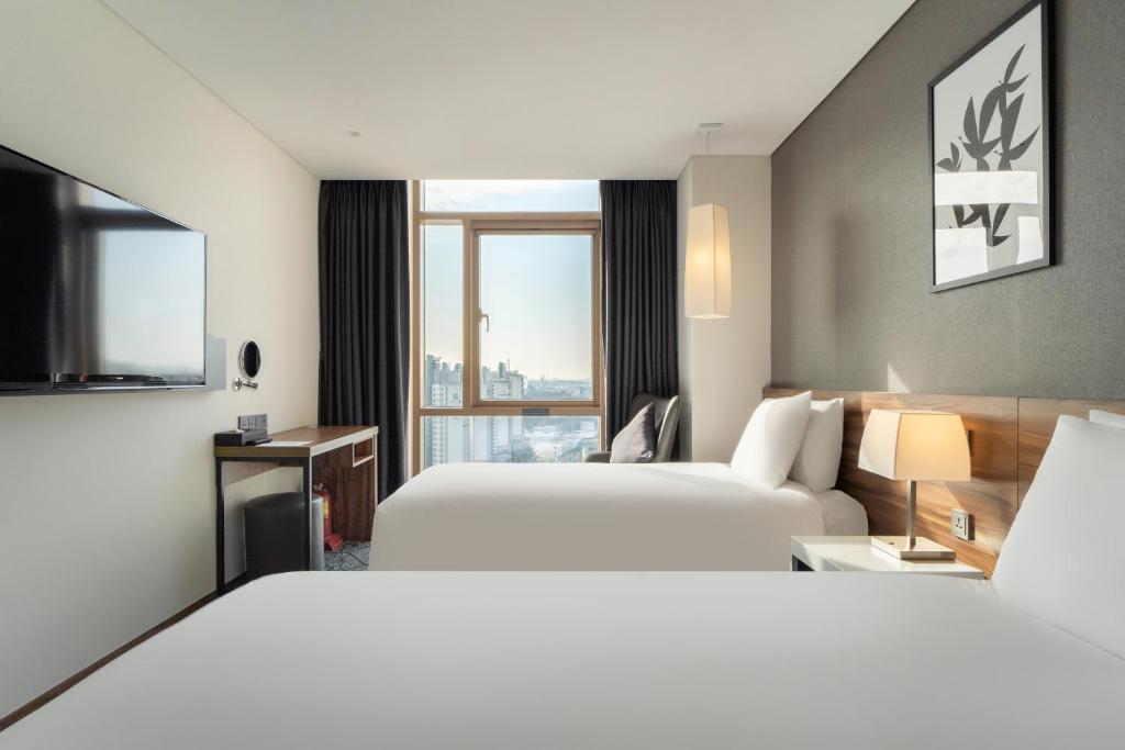 Postel nebo postele na pokoji v ubytování Staz Hotel Ulsan