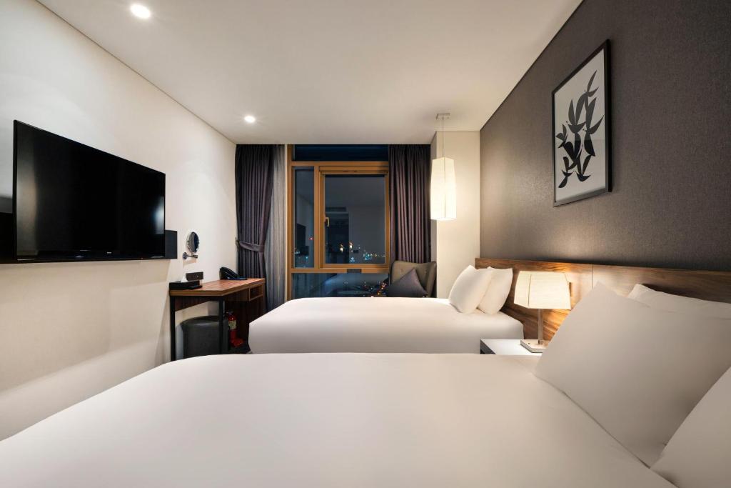 Postel nebo postele na pokoji v ubytování Staz Hotel Ulsan