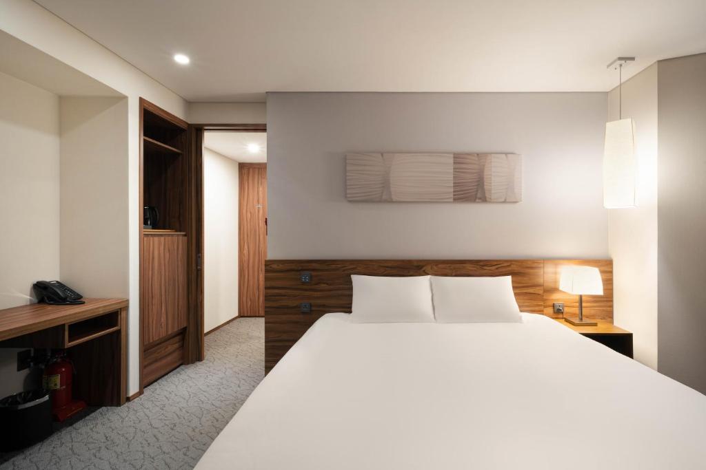 Postel nebo postele na pokoji v ubytování Staz Hotel Ulsan