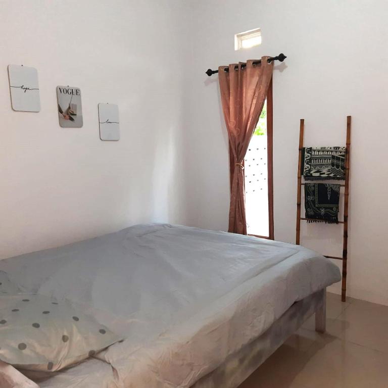 Postel nebo postele na pokoji v ubytování rindoe jogja holiday home