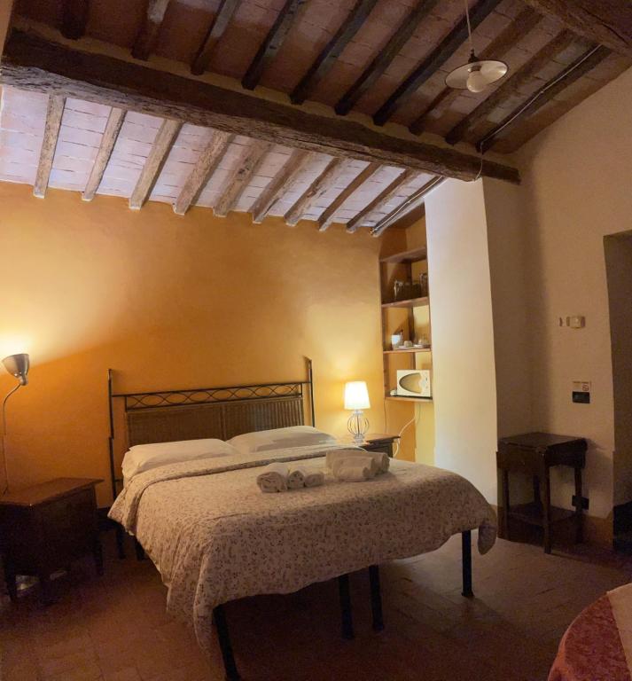 a bedroom with a bed with two stuffed animals on it at Torre Di Ponzano in Barberino di Val dʼElsa