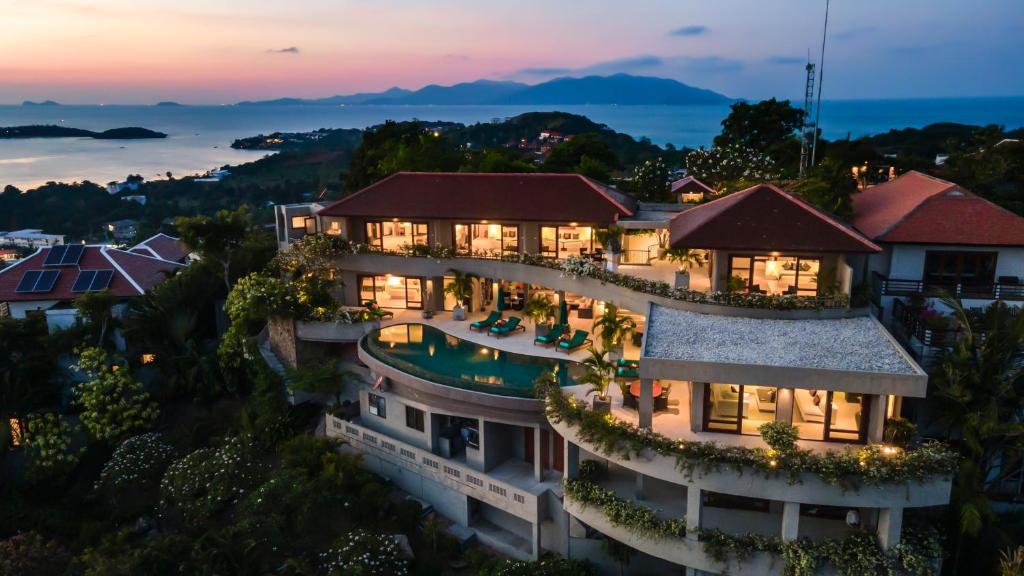 an aerial view of a resort at dusk at Panorama Summit - Private Pool with Sunset View in Plai Laem