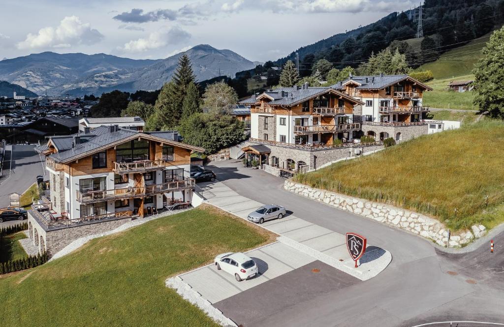 an aerial view of a town with houses and a car at AvenidA Panorama Suites in Kaprun