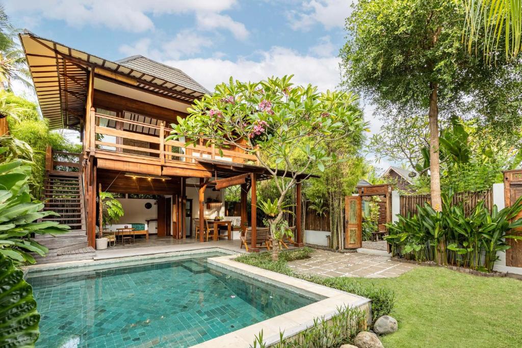 a house with a swimming pool in the backyard at Rimba Villas Gili Air in Gili Islands