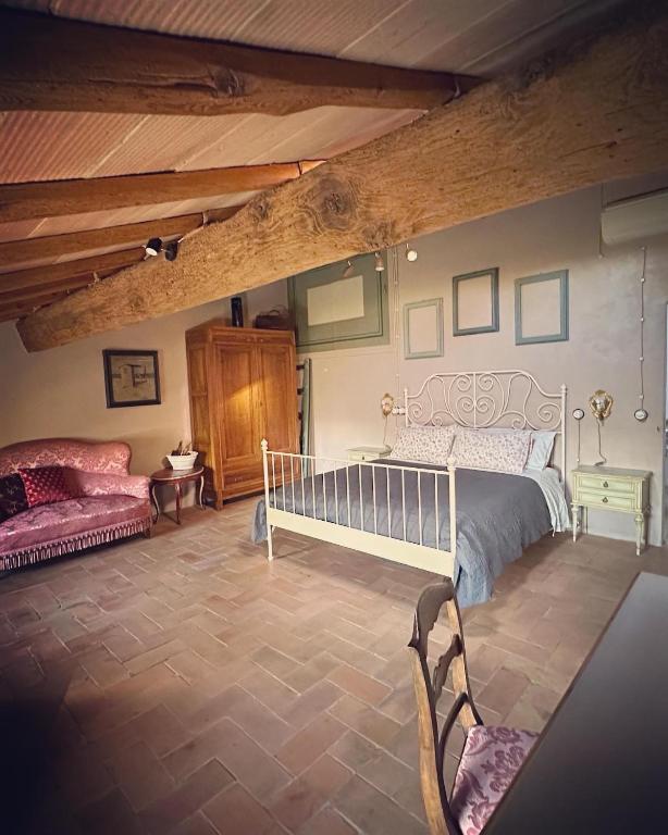 Postel nebo postele na pokoji v ubytování B&B Podere Merlo